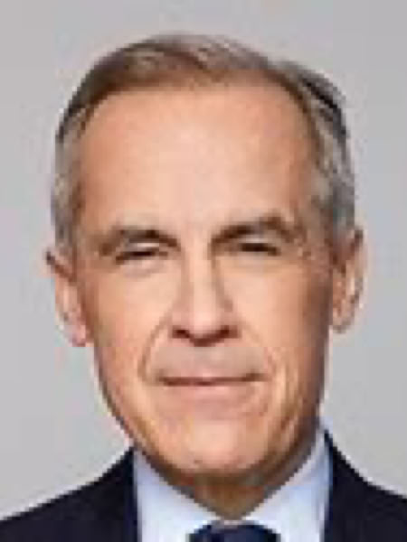 A man with short gray hair wearing a dark suit and tie against a plain background.